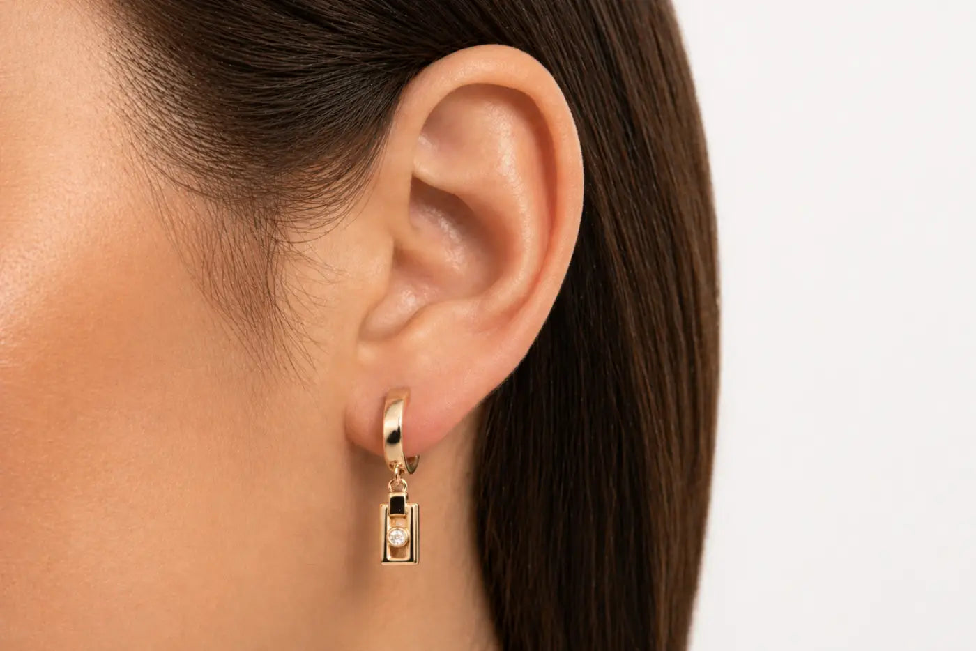Gold-toned solid 14ct yellow gold miler axis drop earrings with rectangular pendant and central 2mm diamond gemstone