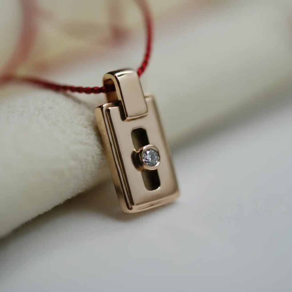 Rose gold Cartier Love series pendant with central round brilliant diamond