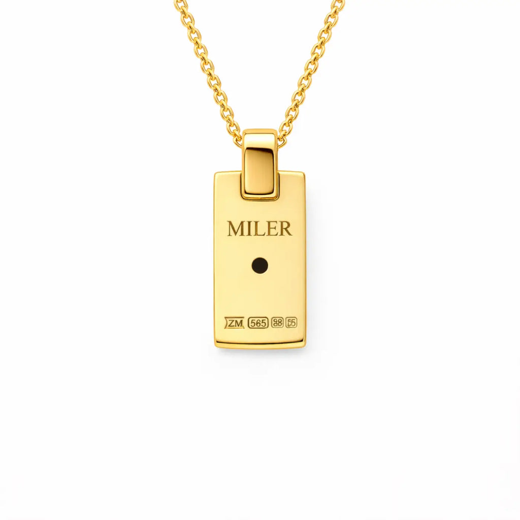 Back of 14k gold diamond pendant with miler engraving and hallmarks