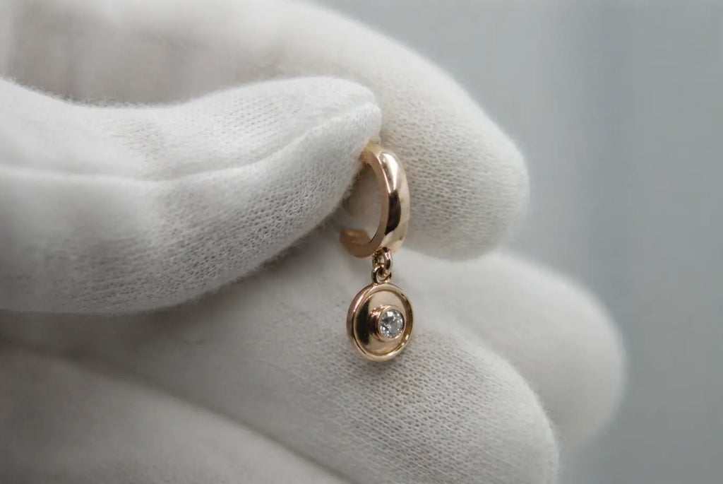 Polished solid 14ct yellow gold hoop earring with a delicate round diamond pendant drop