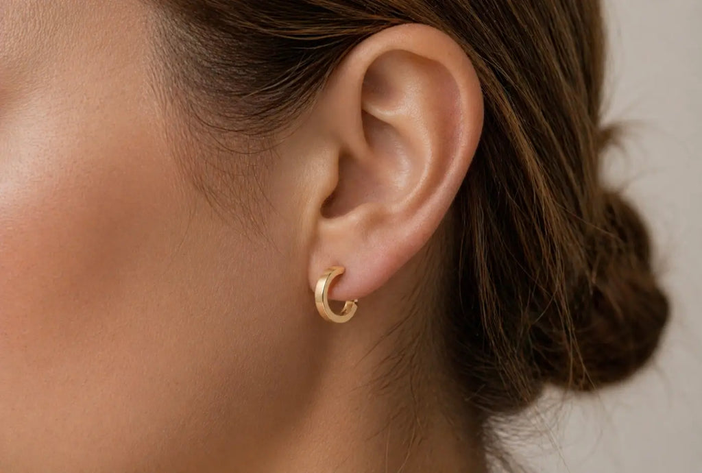 Polished gold hoops featuring delicate yellow gold with a smooth minimalist design and smartlock fastening
