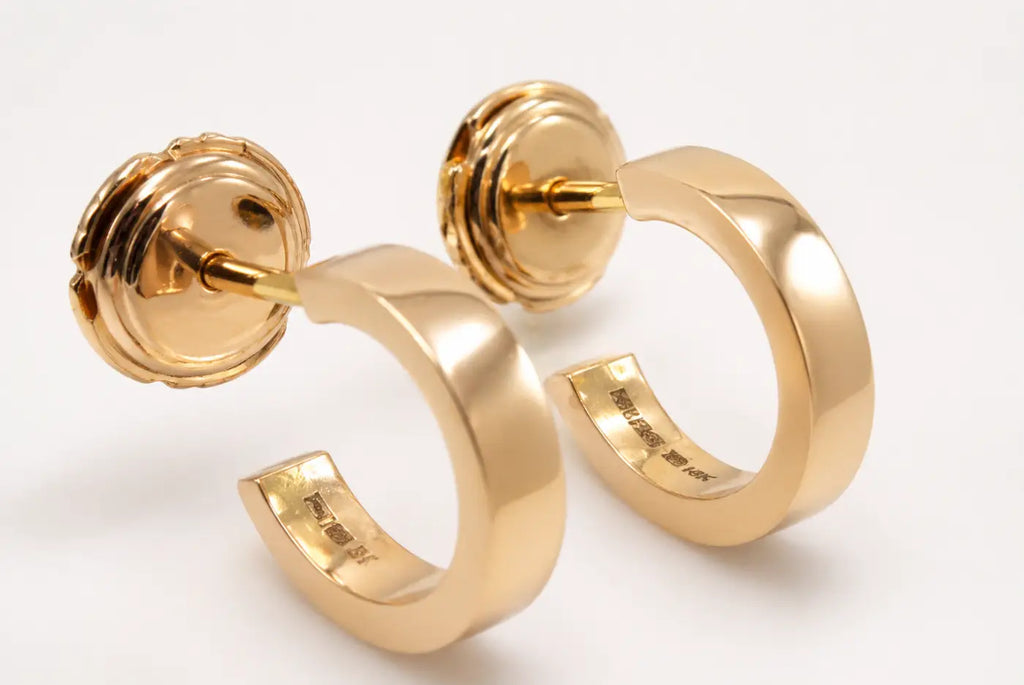 Polished gold hoops with sleek yellow gold finish and subtle engraved markings featuring smartlock fastening