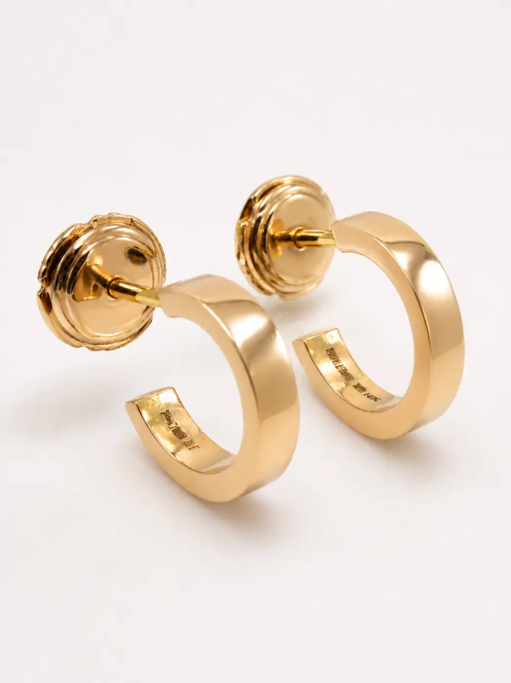 Polished yellow gold hoops with smartlock fastening and subtle inner engraved detailing for minimalist style